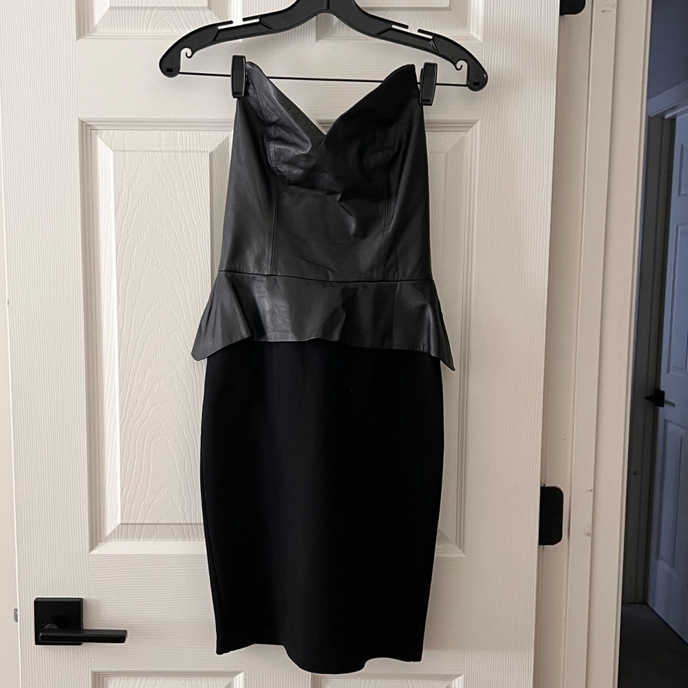 Black peplum dress with leather bodice